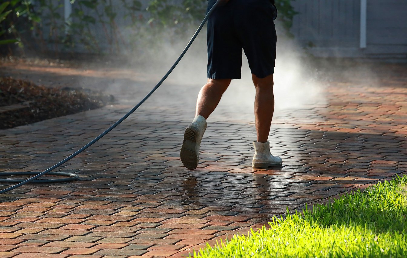 Worker Cleaning Pavers